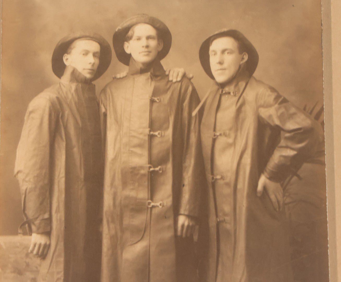 Lot 045 - Antique Trimmed Boarded Photograph Of Three Firefighters In Hats And Slickers Boots Marked J.F.D.
