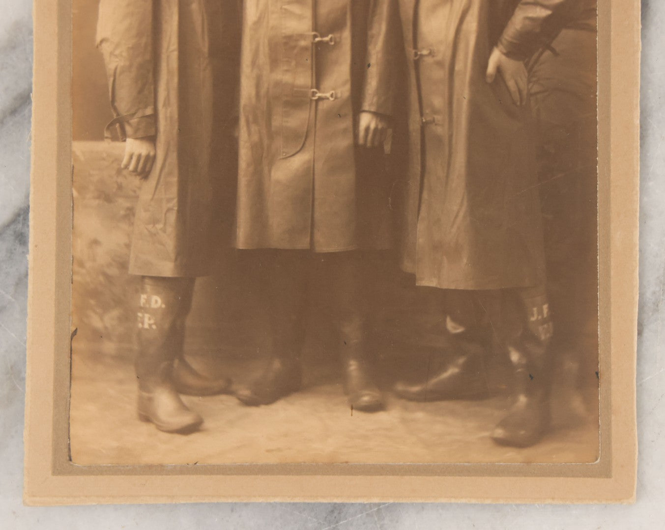 Lot 045 - Antique Trimmed Boarded Photograph Of Three Firefighters In Hats And Slickers Boots Marked J.F.D.