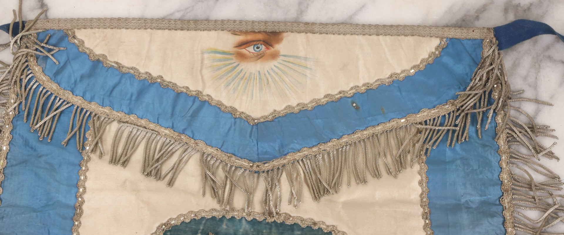 Lot 010 - Antique Odd Fellows I.O.O.F. Fraternal Apron With Embroidered Crossed Swords And Hand Painted All-Seeing-Eye Motifs, Silver Toned Fringe, Blue Coloring