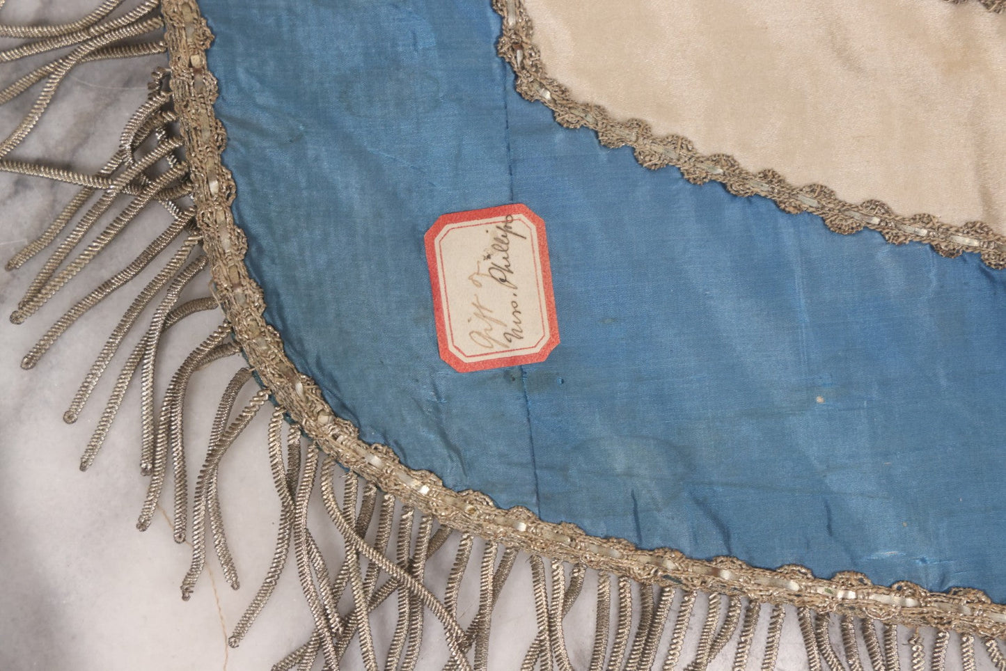 Lot 010 - Antique Odd Fellows I.O.O.F. Fraternal Apron With Embroidered Crossed Swords And Hand Painted All-Seeing-Eye Motifs, Silver Toned Fringe, Blue Coloring