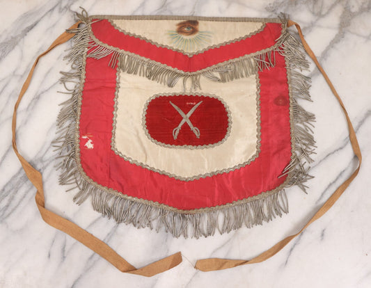 Lot 011 - Antique Odd Fellows I.O.O.F. Fraternal Apron With Embroidered Crossed Swords And Hand Painted All-Seeing-Eye Motifs, Silver Toned Fringe, Red Coloring