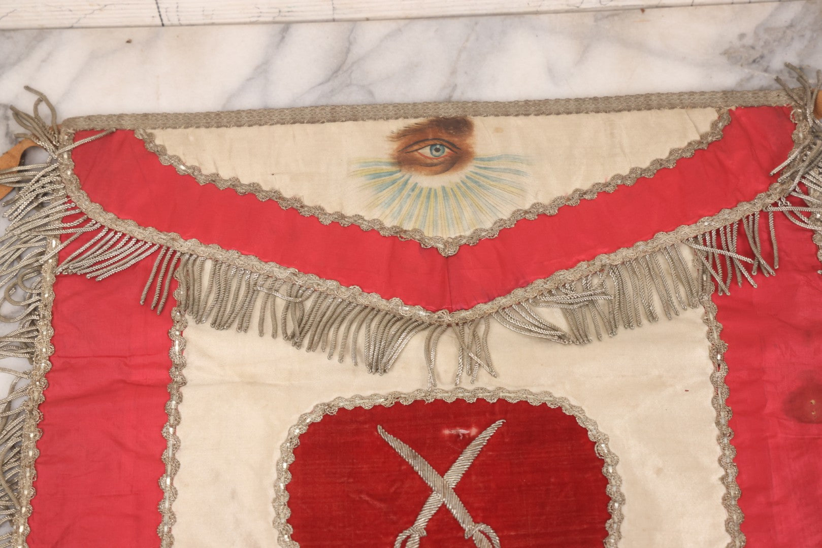 Lot 011 - Antique Odd Fellows I.O.O.F. Fraternal Apron With Embroidered Crossed Swords And Hand Painted All-Seeing-Eye Motifs, Silver Toned Fringe, Red Coloring