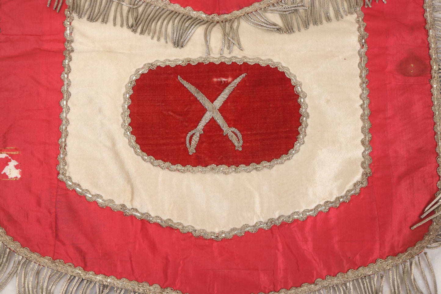 Lot 011 - Antique Odd Fellows I.O.O.F. Fraternal Apron With Embroidered Crossed Swords And Hand Painted All-Seeing-Eye Motifs, Silver Toned Fringe, Red Coloring