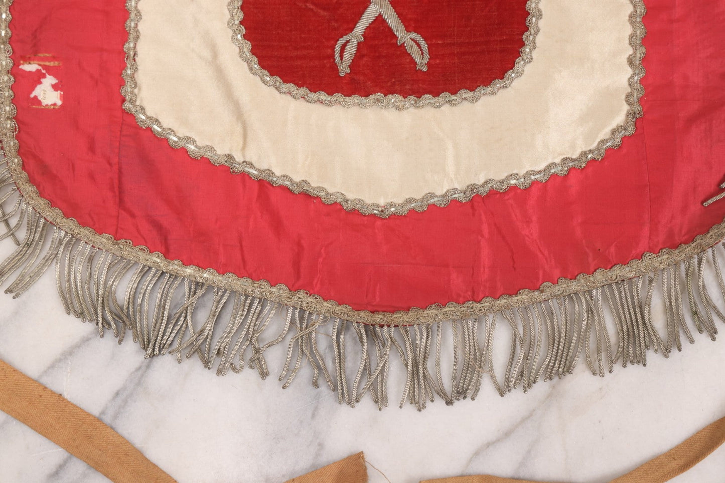 Lot 011 - Antique Odd Fellows I.O.O.F. Fraternal Apron With Embroidered Crossed Swords And Hand Painted All-Seeing-Eye Motifs, Silver Toned Fringe, Red Coloring