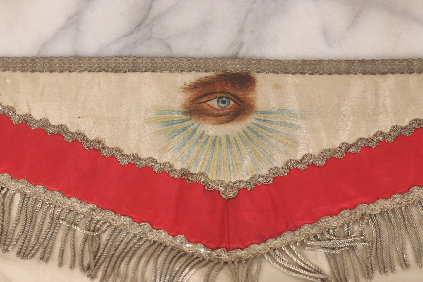 Lot 011 - Antique Odd Fellows I.O.O.F. Fraternal Apron With Embroidered Crossed Swords And Hand Painted All-Seeing-Eye Motifs, Silver Toned Fringe, Red Coloring