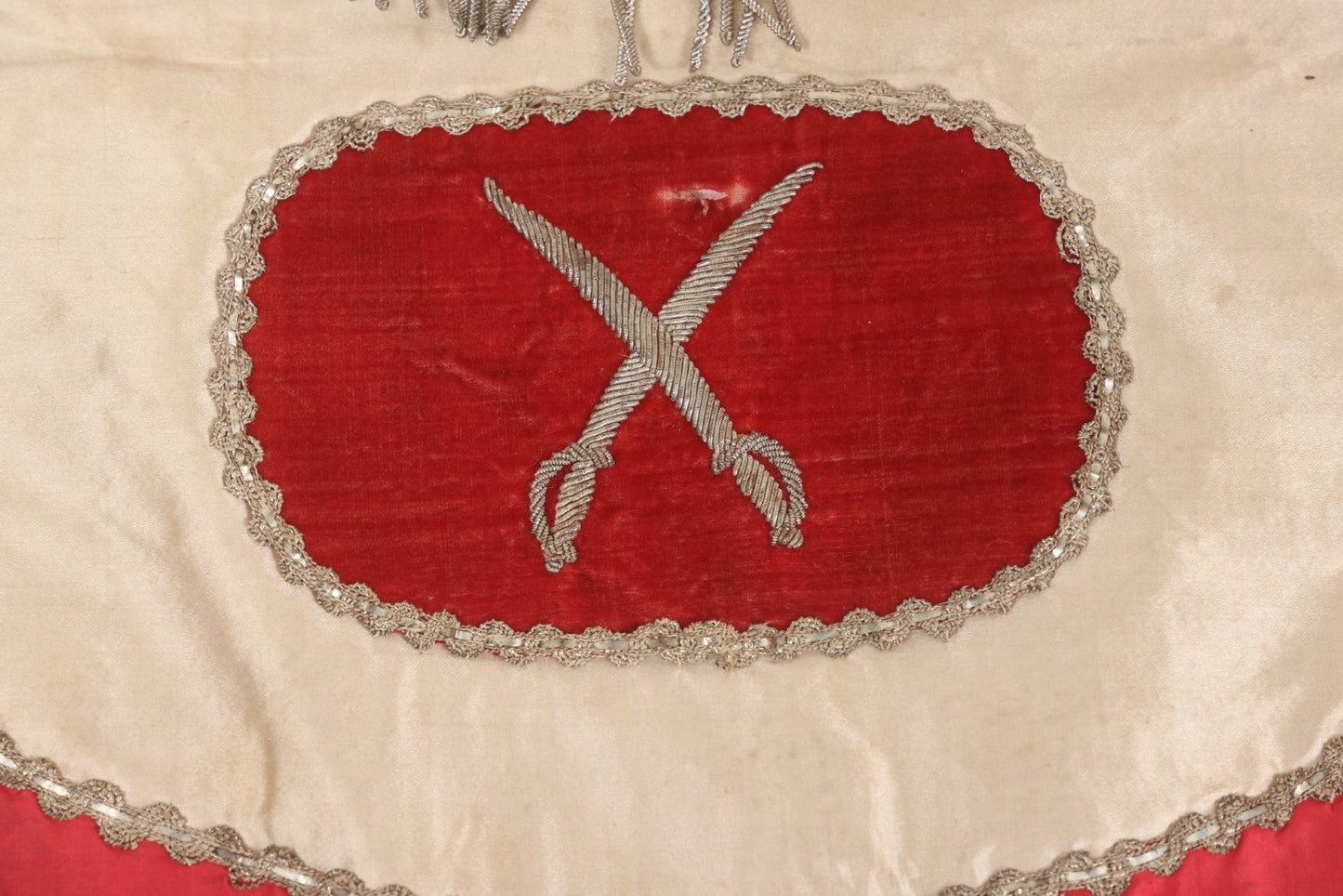 Lot 011 - Antique Odd Fellows I.O.O.F. Fraternal Apron With Embroidered Crossed Swords And Hand Painted All-Seeing-Eye Motifs, Silver Toned Fringe, Red Coloring