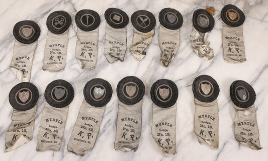 Lot 013 - Grouping Of 15+ Antique Knights Of Pythias Fraternal Badges And Ribbons With Black Coloring, White Ribbons With Black Veil Covering, Pressed Metal Insignia, Myrtle Lodge No. 19, K.P., Kennebunk, Maine