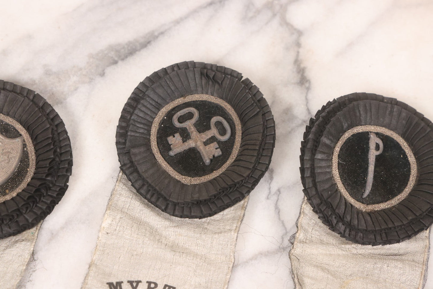 Lot 013 - Grouping Of 15+ Antique Knights Of Pythias Fraternal Badges And Ribbons With Black Coloring, White Ribbons With Black Veil Covering, Pressed Metal Insignia, Myrtle Lodge No. 19, K.P., Kennebunk, Maine