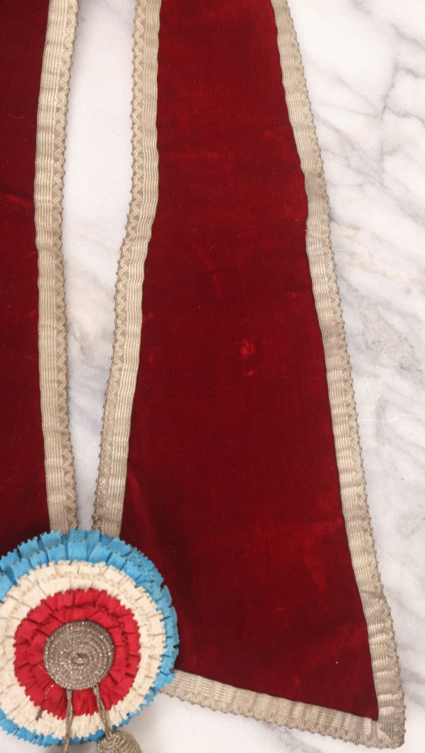 Lot 014 - Single Antique Fraternal Sash Collar With Red Coloring, Red, White, And Blue Fabric Medallion, And Silver Colored Tassels