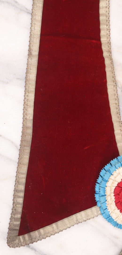 Lot 014 - Single Antique Fraternal Sash Collar With Red Coloring, Red, White, And Blue Fabric Medallion, And Silver Colored Tassels