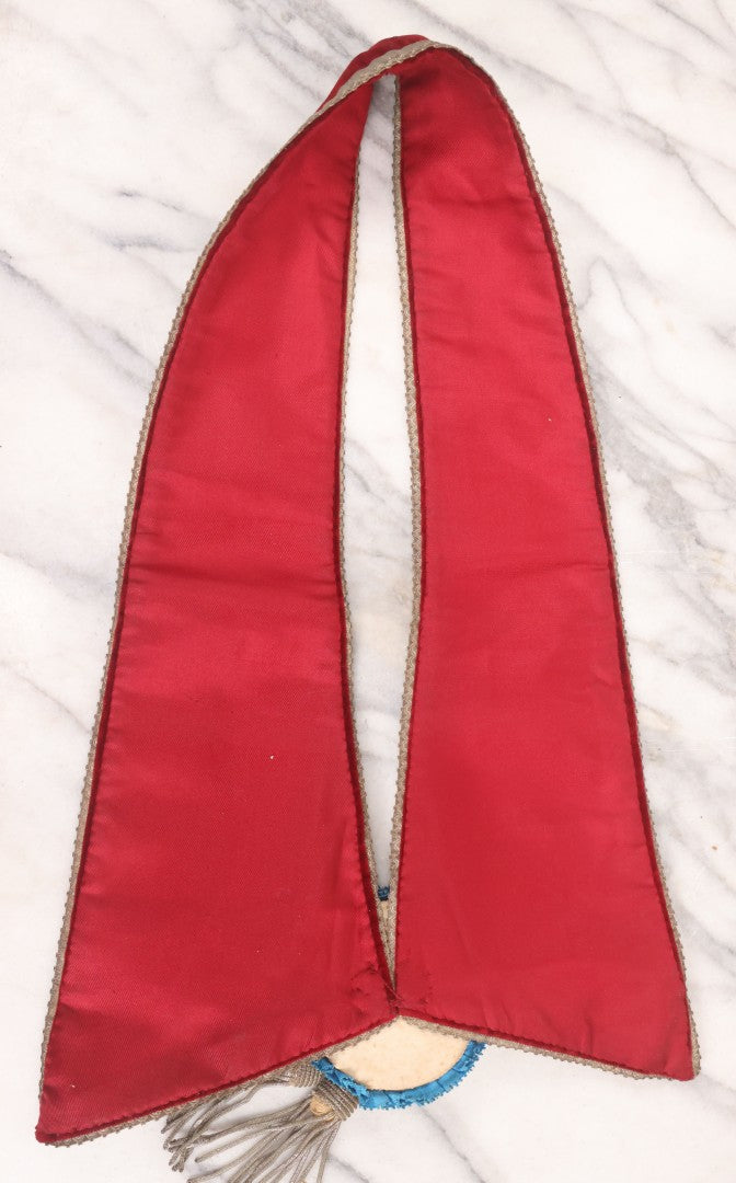 Lot 014 - Single Antique Fraternal Sash Collar With Red Coloring, Red, White, And Blue Fabric Medallion, And Silver Colored Tassels