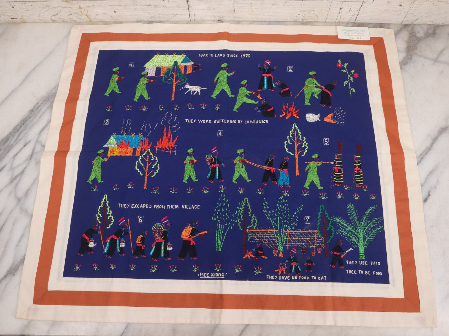 Lot 017 - Pair Of Vintage Folk Art Embroidered Hmong Story Cloths (Paj Ntaub) Illustrating "The War In Laos Since 1976" Across 13 Scenes, Artist Signed Mee Xiong, With Gallery Label From Cama Crafts, Made In Thailand, Circa 1990s