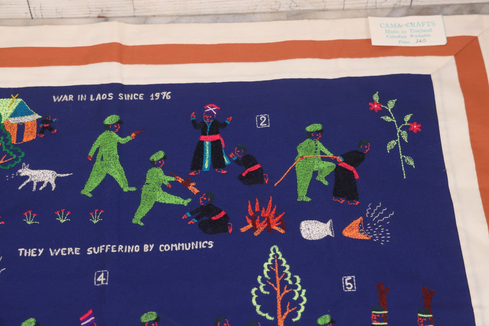 Lot 017 - Pair Of Vintage Folk Art Embroidered Hmong Story Cloths (Paj Ntaub) Illustrating "The War In Laos Since 1976" Across 13 Scenes, Artist Signed Mee Xiong, With Gallery Label From Cama Crafts, Made In Thailand, Circa 1990s