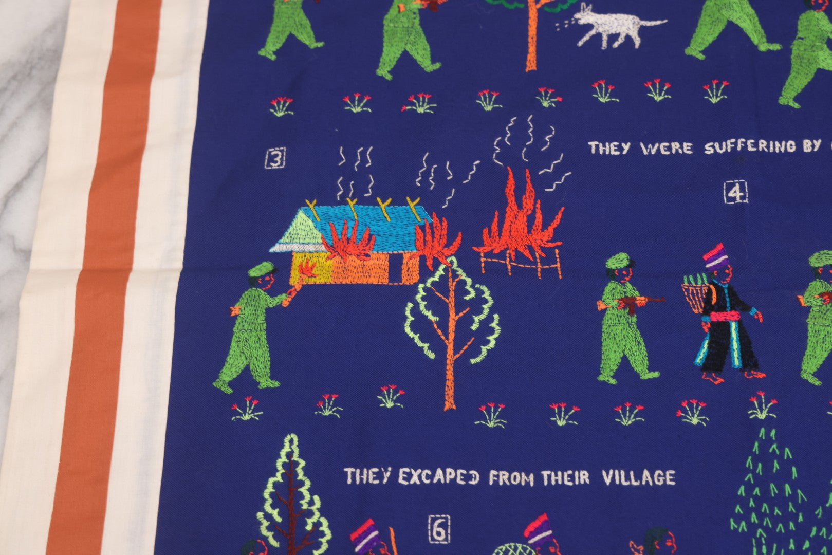 Lot 017 - Pair Of Vintage Folk Art Embroidered Hmong Story Cloths (Paj Ntaub) Illustrating "The War In Laos Since 1976" Across 13 Scenes, Artist Signed Mee Xiong, With Gallery Label From Cama Crafts, Made In Thailand, Circa 1990s