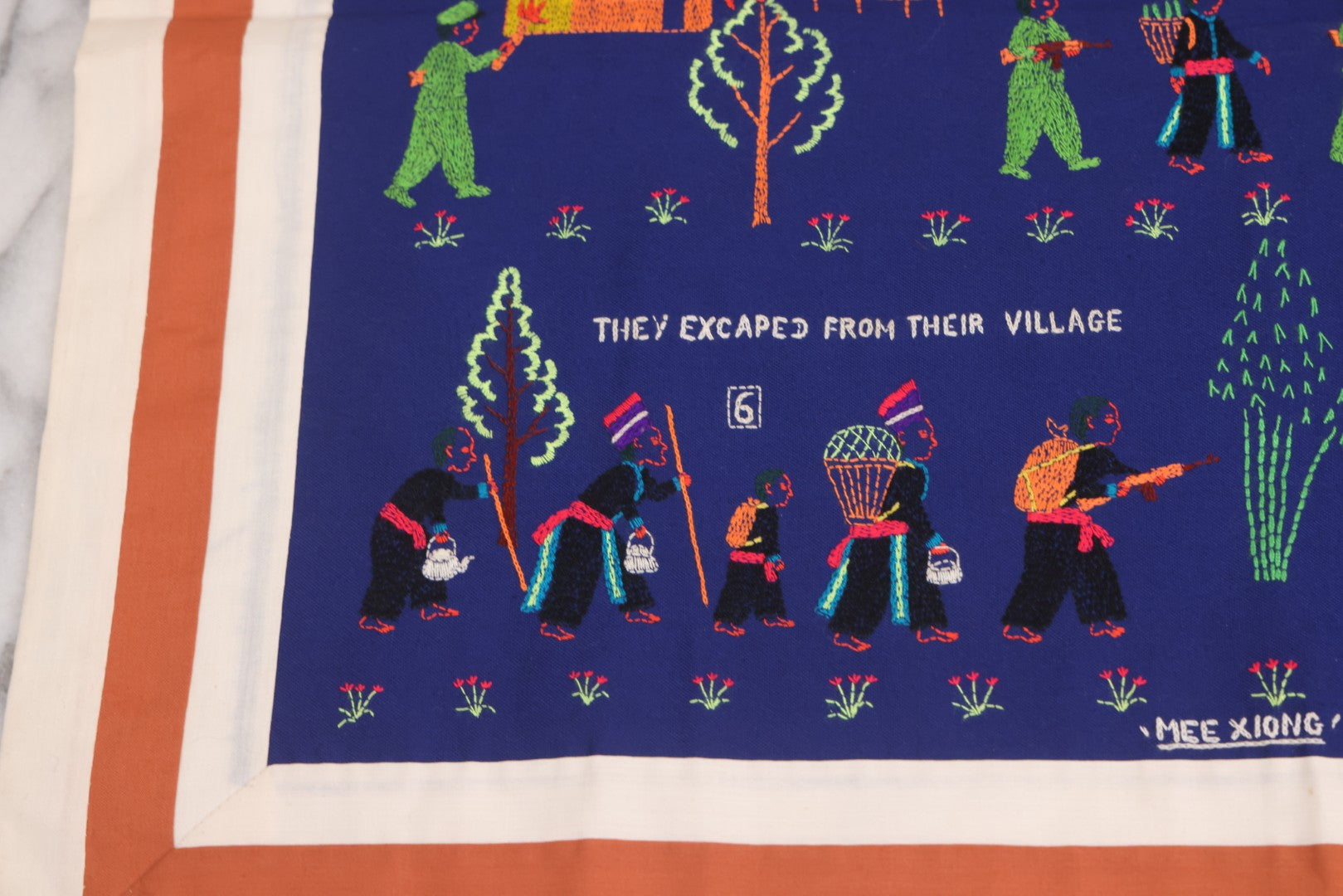 Lot 017 - Pair Of Vintage Folk Art Embroidered Hmong Story Cloths (Paj Ntaub) Illustrating "The War In Laos Since 1976" Across 13 Scenes, Artist Signed Mee Xiong, With Gallery Label From Cama Crafts, Made In Thailand, Circa 1990s