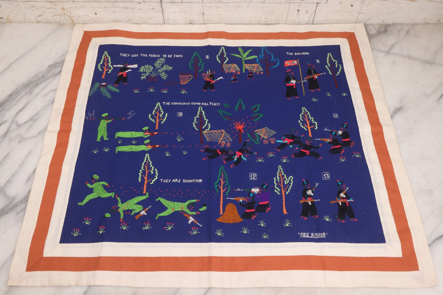 Lot 017 - Pair Of Vintage Folk Art Embroidered Hmong Story Cloths (Paj Ntaub) Illustrating "The War In Laos Since 1976" Across 13 Scenes, Artist Signed Mee Xiong, With Gallery Label From Cama Crafts, Made In Thailand, Circa 1990s