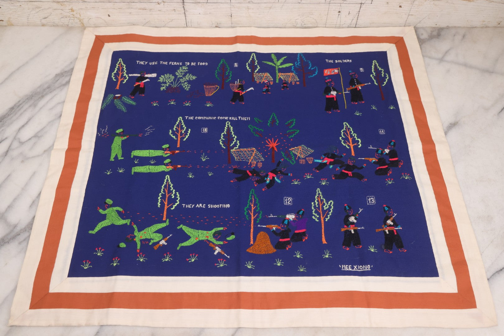 Lot 017 - Pair Of Vintage Folk Art Embroidered Hmong Story Cloths (Paj Ntaub) Illustrating "The War In Laos Since 1976" Across 13 Scenes, Artist Signed Mee Xiong, With Gallery Label From Cama Crafts, Made In Thailand, Circa 1990s