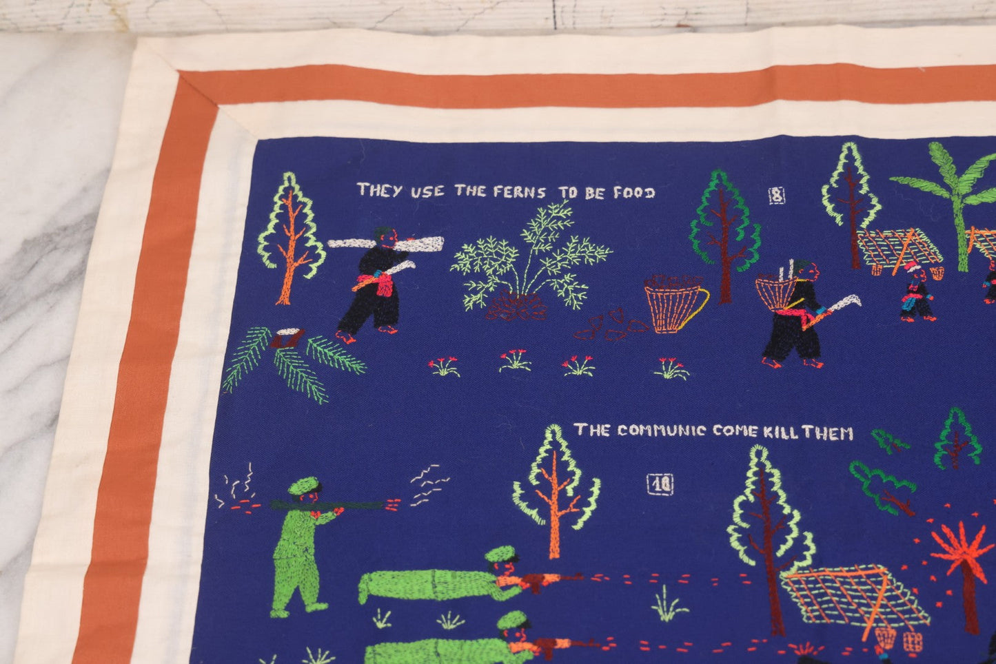 Lot 017 - Pair Of Vintage Folk Art Embroidered Hmong Story Cloths (Paj Ntaub) Illustrating "The War In Laos Since 1976" Across 13 Scenes, Artist Signed Mee Xiong, With Gallery Label From Cama Crafts, Made In Thailand, Circa 1990s