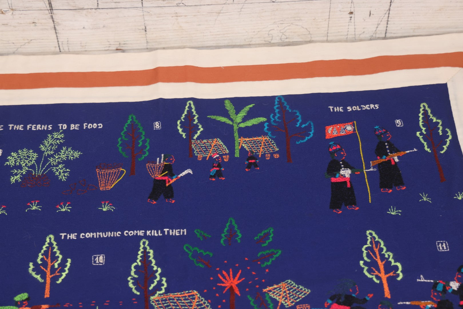 Lot 017 - Pair Of Vintage Folk Art Embroidered Hmong Story Cloths (Paj Ntaub) Illustrating "The War In Laos Since 1976" Across 13 Scenes, Artist Signed Mee Xiong, With Gallery Label From Cama Crafts, Made In Thailand, Circa 1990s