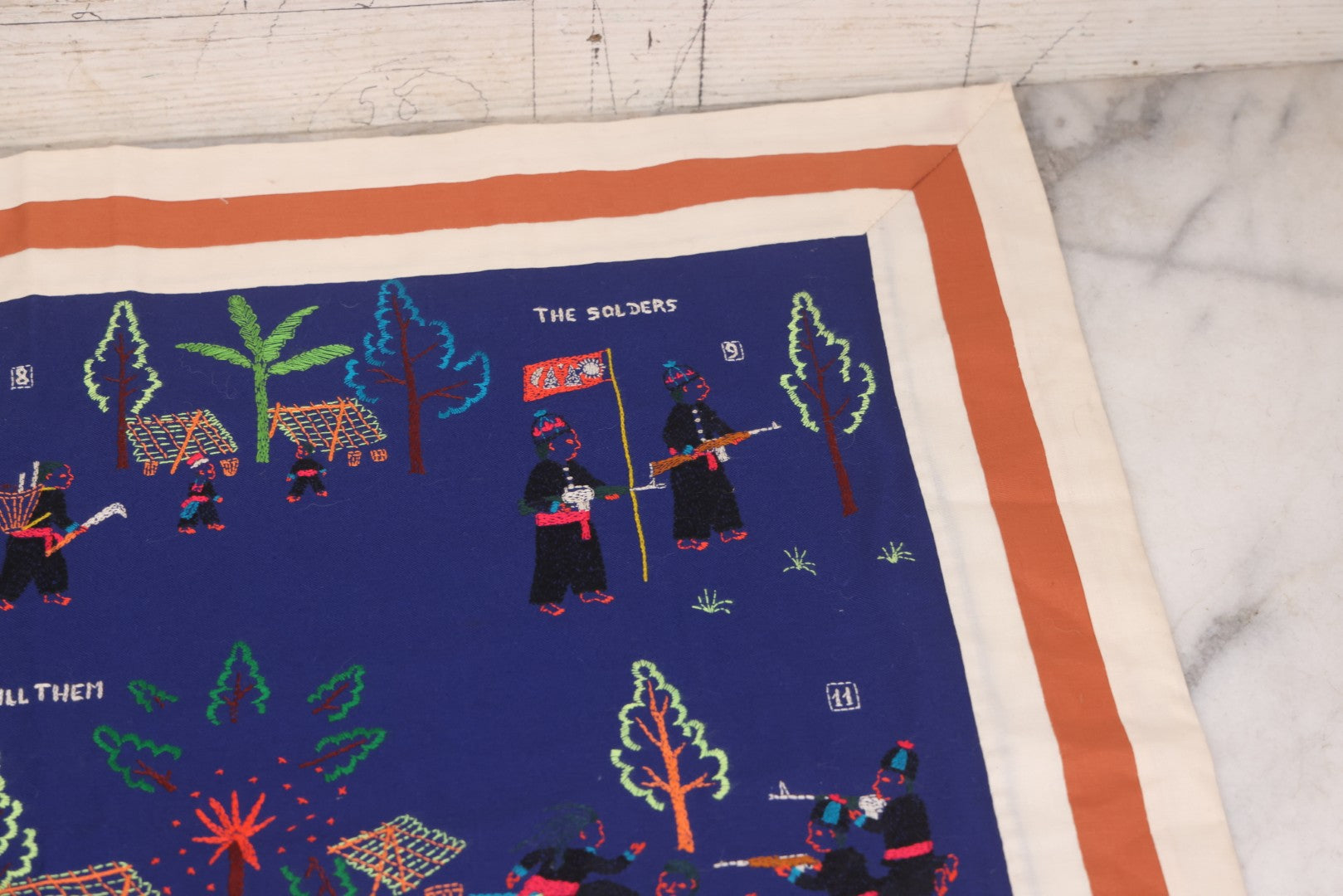 Lot 017 - Pair Of Vintage Folk Art Embroidered Hmong Story Cloths (Paj Ntaub) Illustrating "The War In Laos Since 1976" Across 13 Scenes, Artist Signed Mee Xiong, With Gallery Label From Cama Crafts, Made In Thailand, Circa 1990s