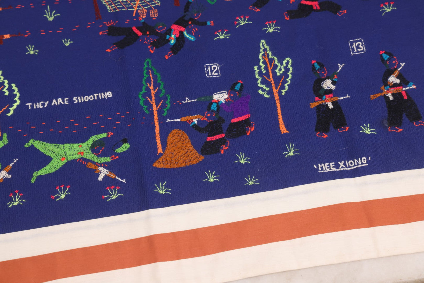 Lot 017 - Pair Of Vintage Folk Art Embroidered Hmong Story Cloths (Paj Ntaub) Illustrating "The War In Laos Since 1976" Across 13 Scenes, Artist Signed Mee Xiong, With Gallery Label From Cama Crafts, Made In Thailand, Circa 1990s