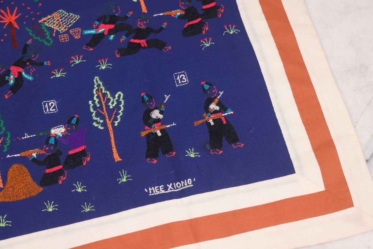 Lot 017 - Pair Of Vintage Folk Art Embroidered Hmong Story Cloths (Paj Ntaub) Illustrating "The War In Laos Since 1976" Across 13 Scenes, Artist Signed Mee Xiong, With Gallery Label From Cama Crafts, Made In Thailand, Circa 1990s