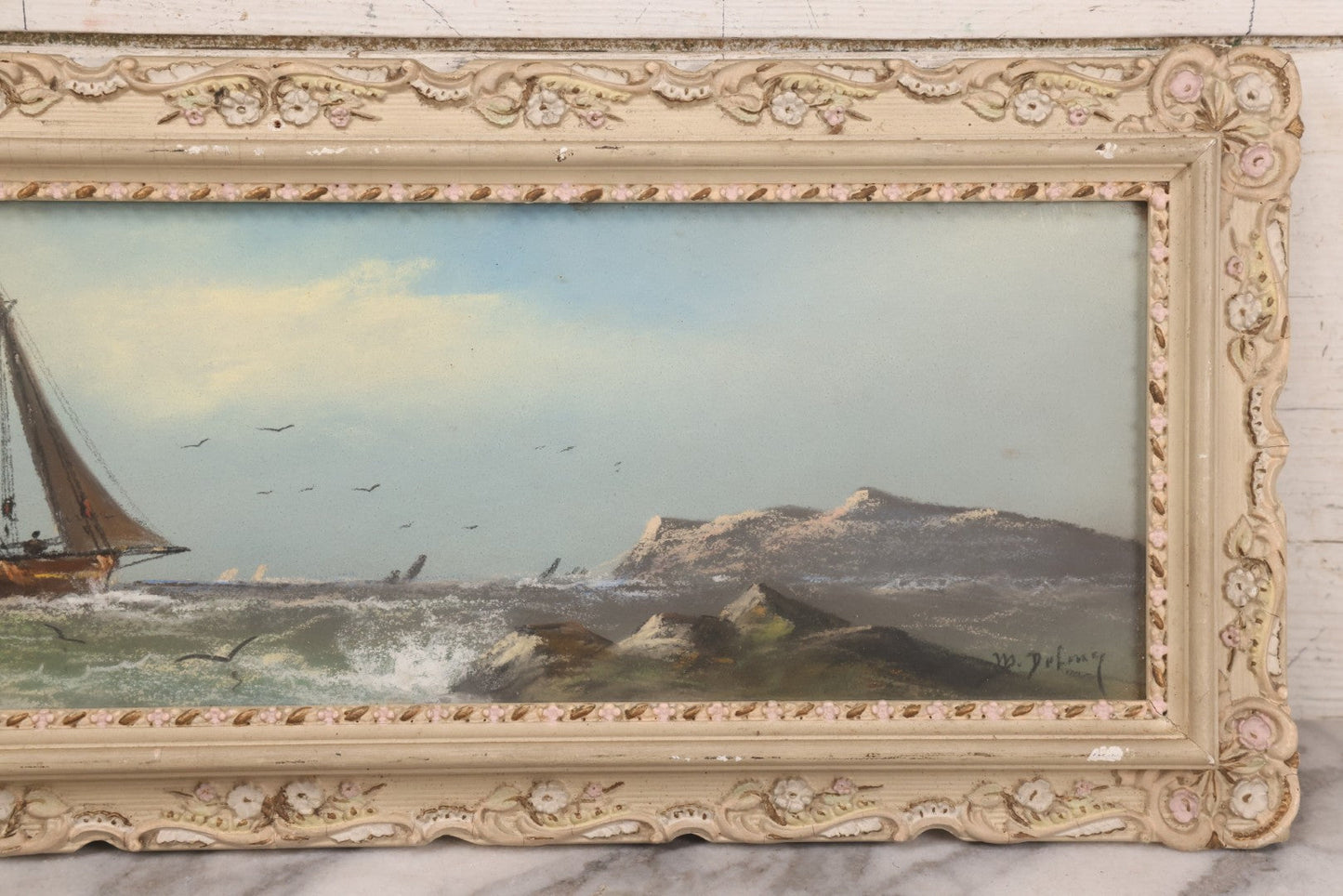 Lot 024 - Antique Nautical Pastel Painting Of A Sailing Ship On Choppy Waters, With Coastal Mountains, Other Ships In Background, Artist Signed M. Dulmy, In Original Painted Pressed Gesso Custom Frame, 23" x 9"