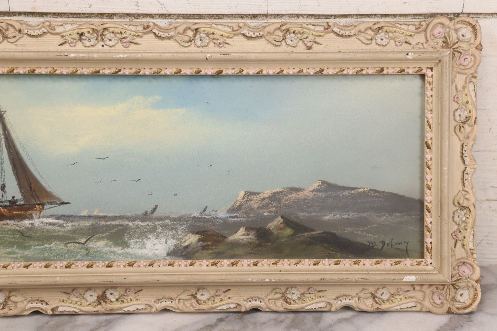 Lot 024 - Antique Nautical Pastel Painting Of A Sailing Ship On Choppy Waters, With Coastal Mountains, Other Ships In Background, Artist Signed M. Dulmy, In Original Painted Pressed Gesso Custom Frame, 23" x 9"