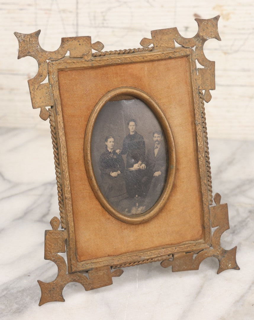 Lot 038 - Antique Cut Brass Frame Tintype Photo Frame With Orange Velvet Surround, Including Tintype Of Two Women And Man, As Found, With Wire Kick Stand, 5-5/8" x 7"