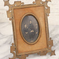 Lot 038 - Antique Cut Brass Frame Tintype Photo Frame With Orange Velvet Surround, Including Tintype Of Two Women And Man, As Found, With Wire Kick Stand, 5-5/8" x 7"