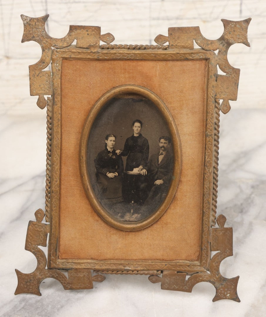 Lot 038 - Antique Cut Brass Frame Tintype Photo Frame With Orange Velvet Surround, Including Tintype Of Two Women And Man, As Found, With Wire Kick Stand, 5-5/8" x 7"