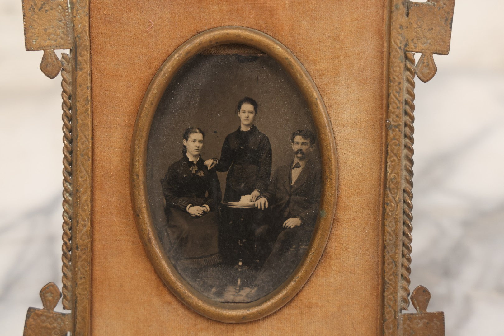Lot 038 - Antique Cut Brass Frame Tintype Photo Frame With Orange Velvet Surround, Including Tintype Of Two Women And Man, As Found, With Wire Kick Stand, 5-5/8" x 7"