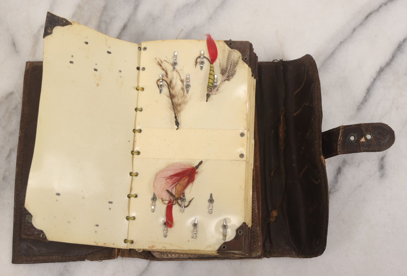 Lot 050 - Antique Leather Fly Fisherman's Wallet Book With Celluloid Pages, Many Fly Fishing Lures, Some Marked "Playfair's, Made In Scotland," Note Flies Have Varying Degrees Of Ware, Losses, As Found