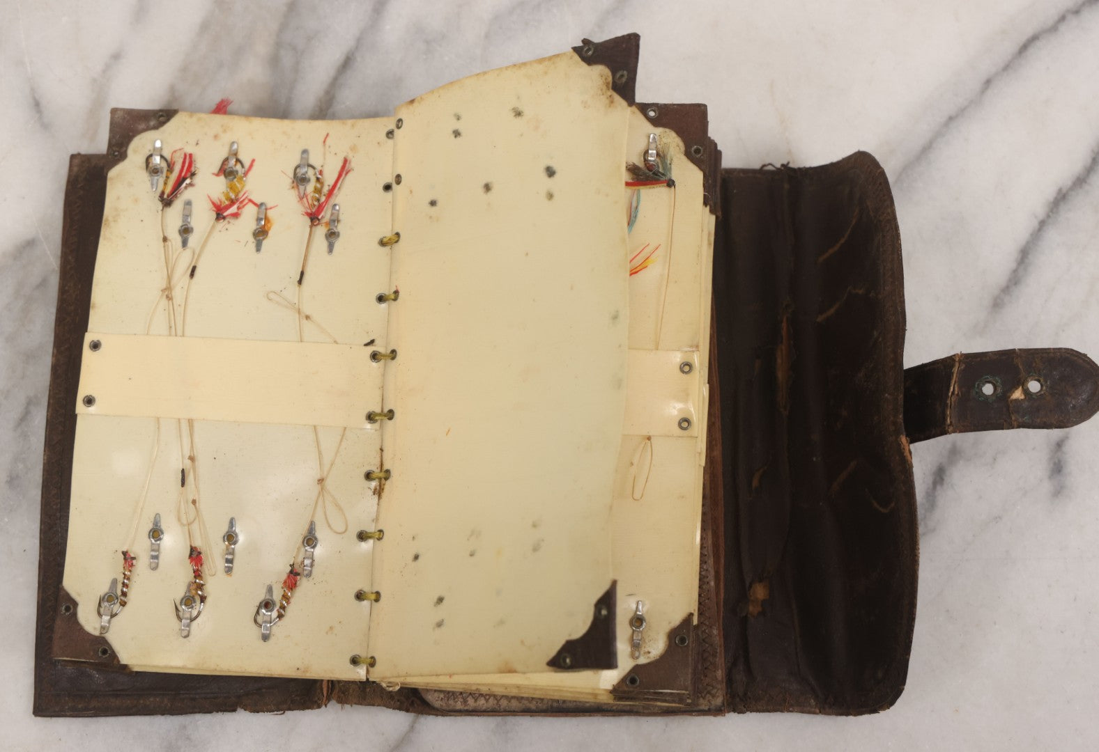 Lot 050 - Antique Leather Fly Fisherman's Wallet Book With Celluloid Pages, Many Fly Fishing Lures, Some Marked "Playfair's, Made In Scotland," Note Flies Have Varying Degrees Of Ware, Losses, As Found