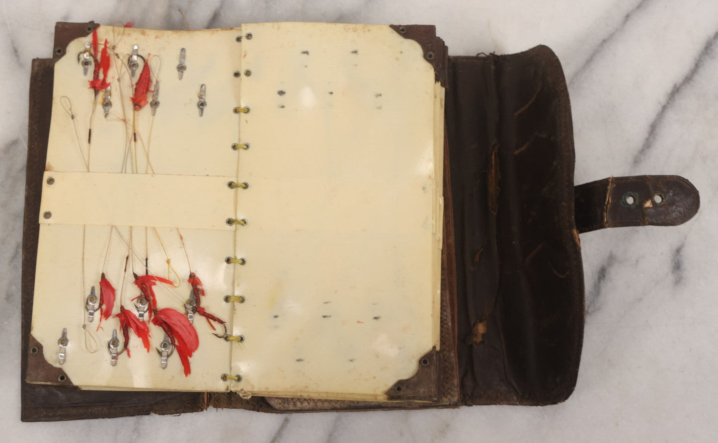 Lot 050 - Antique Leather Fly Fisherman's Wallet Book With Celluloid Pages, Many Fly Fishing Lures, Some Marked "Playfair's, Made In Scotland," Note Flies Have Varying Degrees Of Ware, Losses, As Found