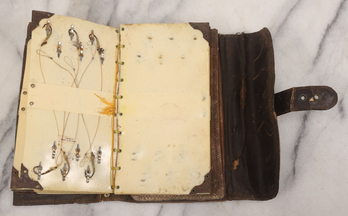 Lot 050 - Antique Leather Fly Fisherman's Wallet Book With Celluloid Pages, Many Fly Fishing Lures, Some Marked "Playfair's, Made In Scotland," Note Flies Have Varying Degrees Of Ware, Losses, As Found