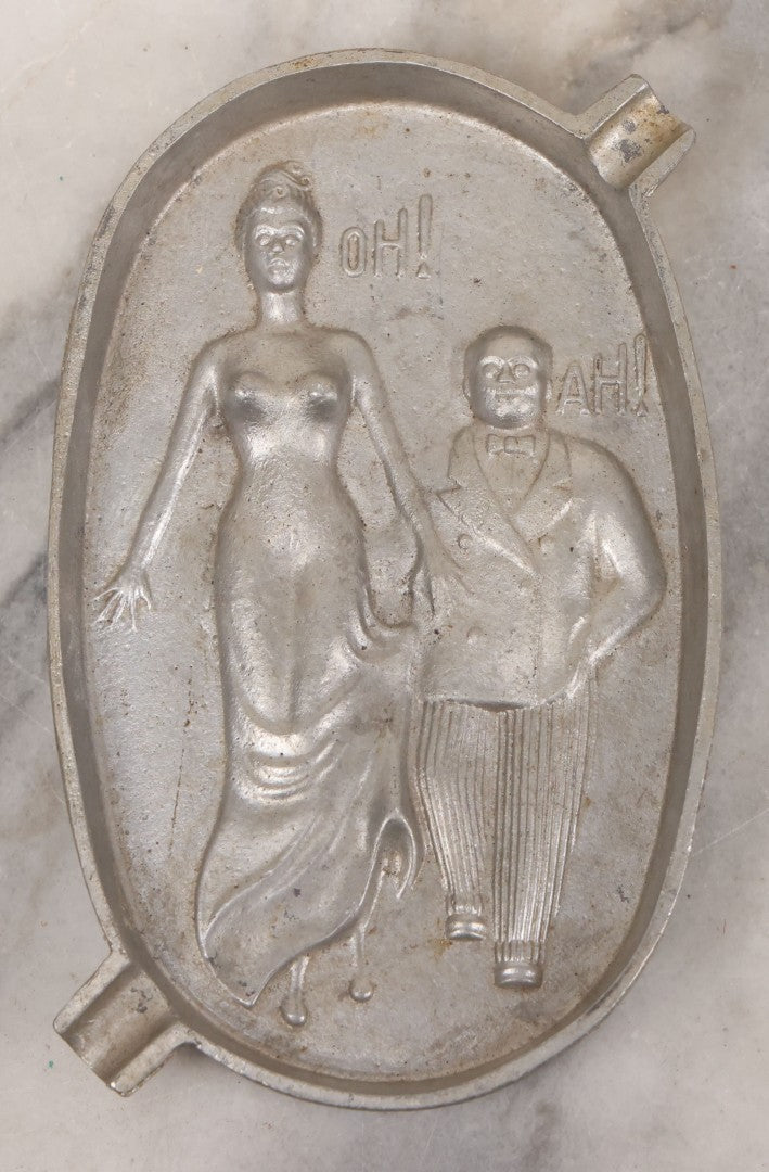 Lot 055 - Vintage Cast Aluminum "Oh! Ah!" Risqué Ashtray With Little Man Grabbing A Surprised Lady's Behind 