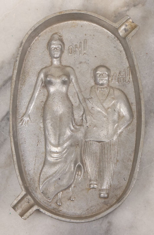 Lot 055 - Vintage Cast Aluminum "Oh! Ah!" Risqué Ashtray With Little Man Grabbing A Surprised Lady's Behind 