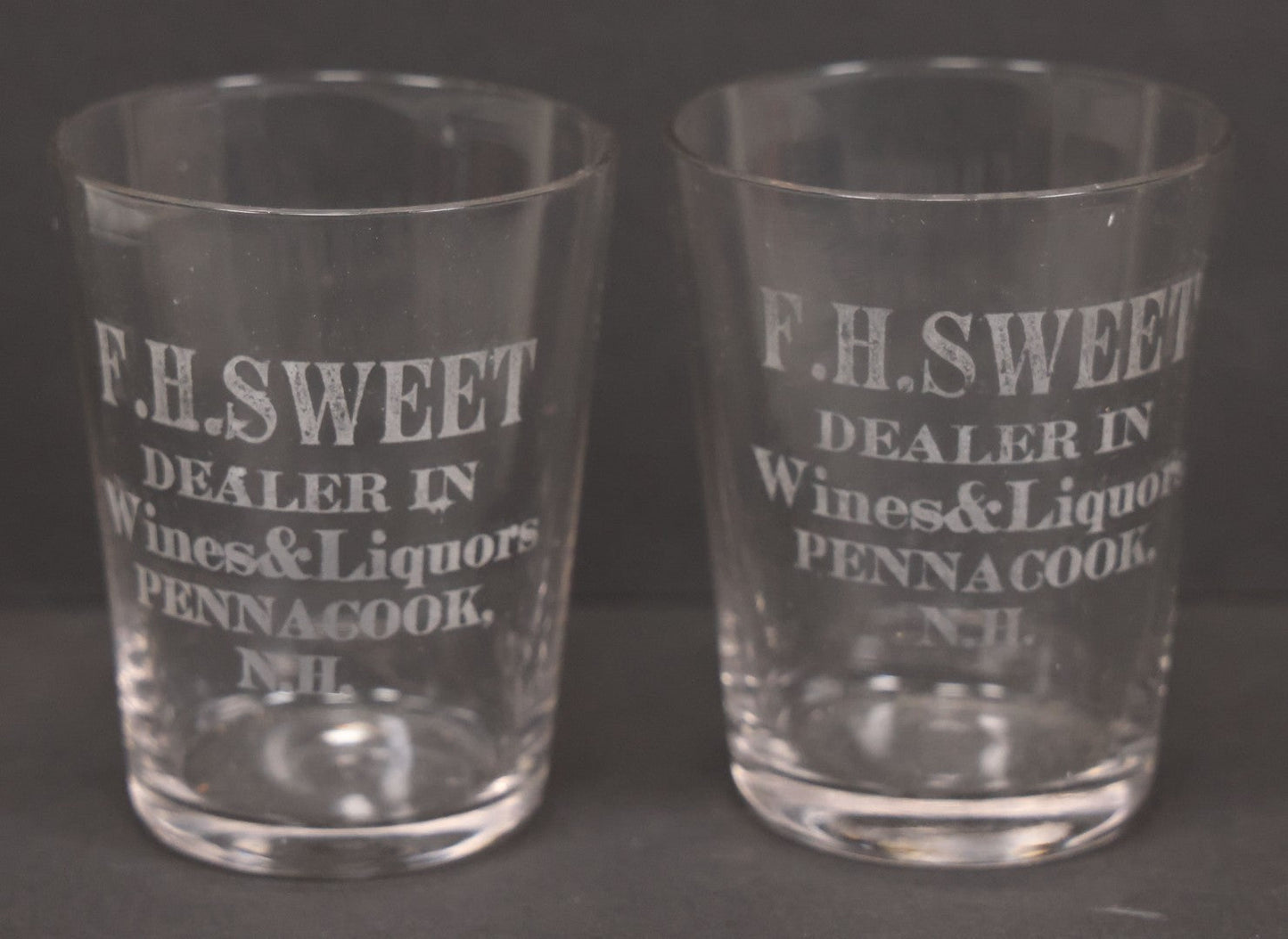 Lot 056 - Pair Of Vintage Glass Shot Glasses Advertising F.H. Sweet, Dealer In Wines & Liquors, Pennacook, New Hampshire