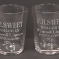 Lot 056 - Pair Of Vintage Glass Shot Glasses Advertising F.H. Sweet, Dealer In Wines & Liquors, Pennacook, New Hampshire