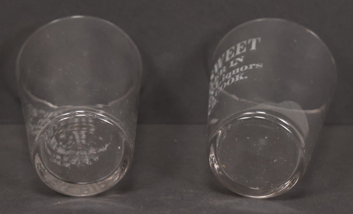 Lot 056 - Pair Of Vintage Glass Shot Glasses Advertising F.H. Sweet, Dealer In Wines & Liquors, Pennacook, New Hampshire
