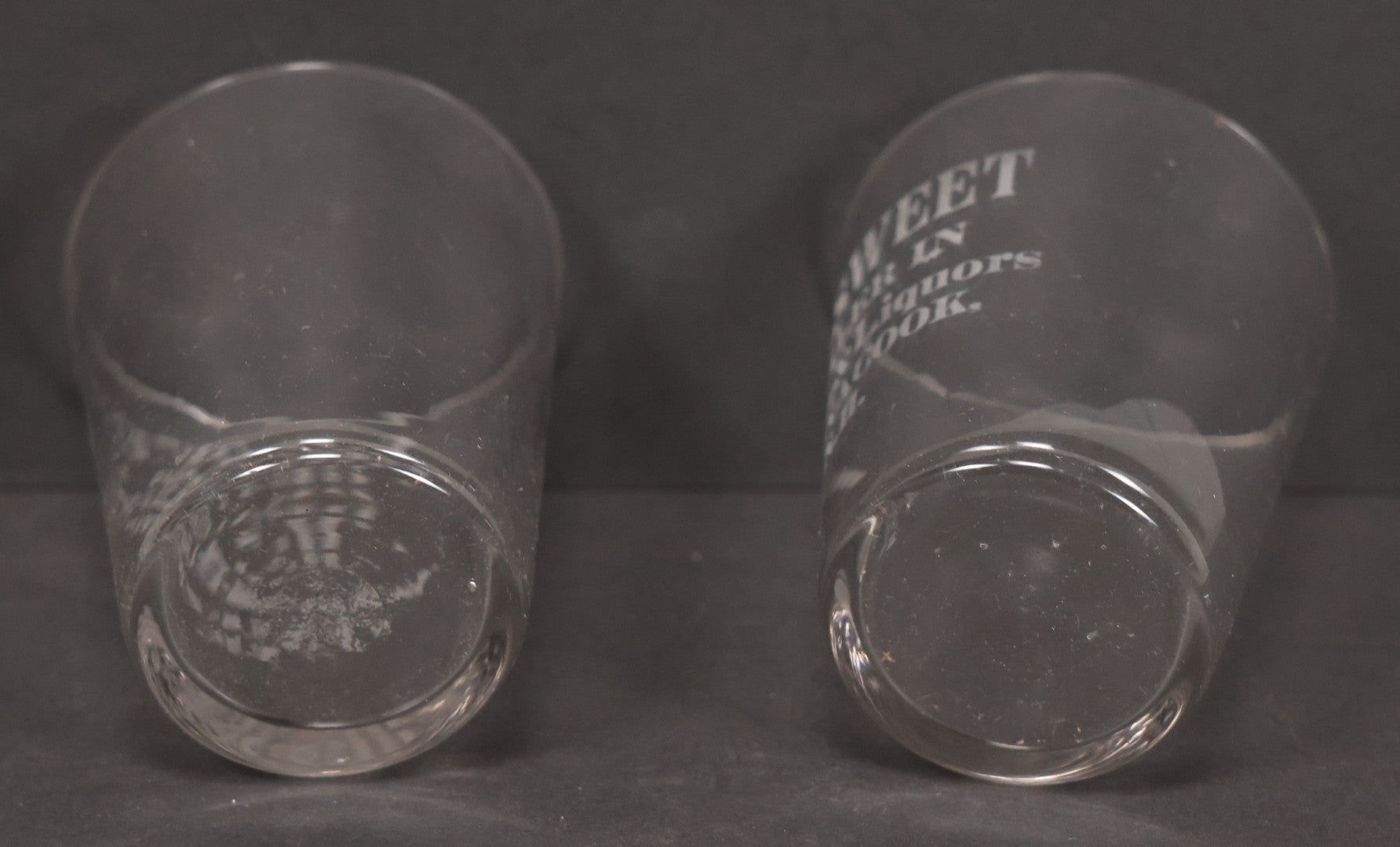 Lot 056 - Pair Of Vintage Glass Shot Glasses Advertising F.H. Sweet, Dealer In Wines & Liquors, Pennacook, New Hampshire