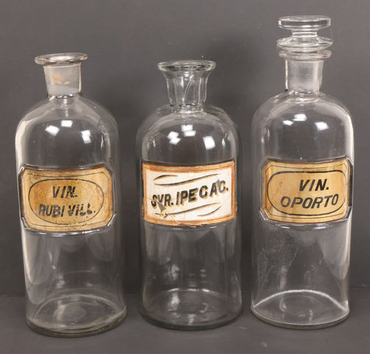 Lot 057 - Grouping Of Three Antique Glass Apothecary Bottles With Reverse Painted Glass Labels Including Syrup Of Ipecac (Syr. Ipecac.), Blackberry Wine (Vin. Rubi Vill.), And Port Wine (Vin. Oporto)
