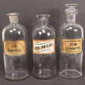 Lot 057 - Grouping Of Three Antique Glass Apothecary Bottles With Reverse Painted Glass Labels Including Syrup Of Ipecac (Syr. Ipecac.), Blackberry Wine (Vin. Rubi Vill.), And Port Wine (Vin. Oporto)