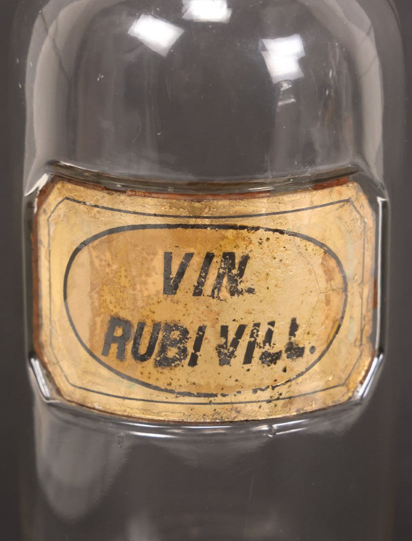 Lot 057 - Grouping Of Three Antique Glass Apothecary Bottles With Reverse Painted Glass Labels Including Syrup Of Ipecac (Syr. Ipecac.), Blackberry Wine (Vin. Rubi Vill.), And Port Wine (Vin. Oporto)