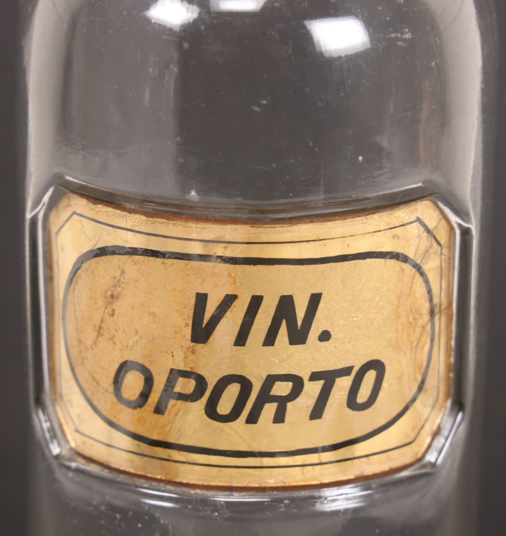 Lot 057 - Grouping Of Three Antique Glass Apothecary Bottles With Reverse Painted Glass Labels Including Syrup Of Ipecac (Syr. Ipecac.), Blackberry Wine (Vin. Rubi Vill.), And Port Wine (Vin. Oporto)