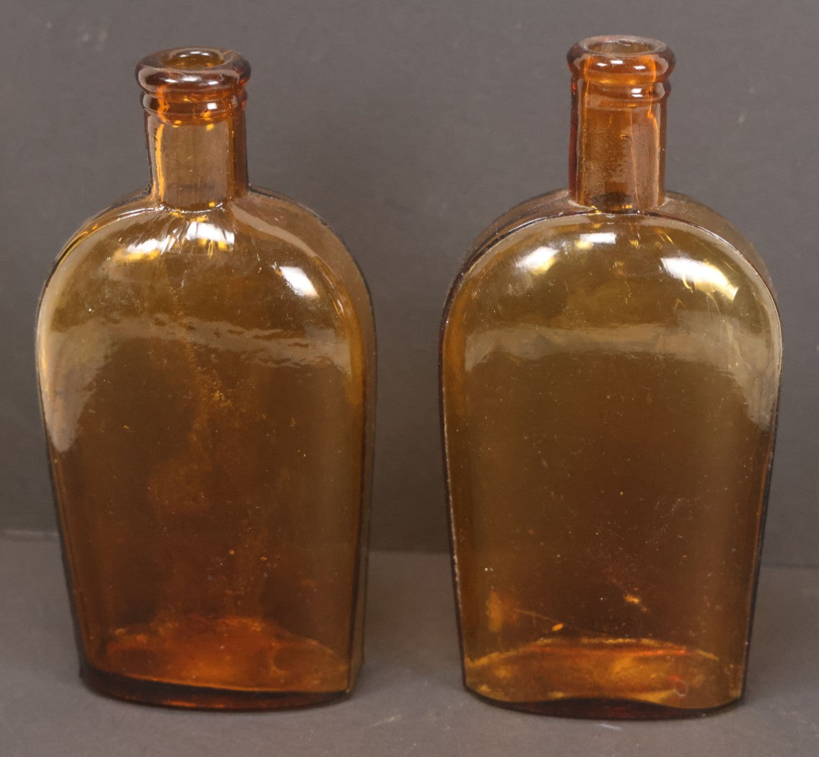 Lot 059 - Pair Of Antique Amber Glass Flask Bottles With Textured Glass