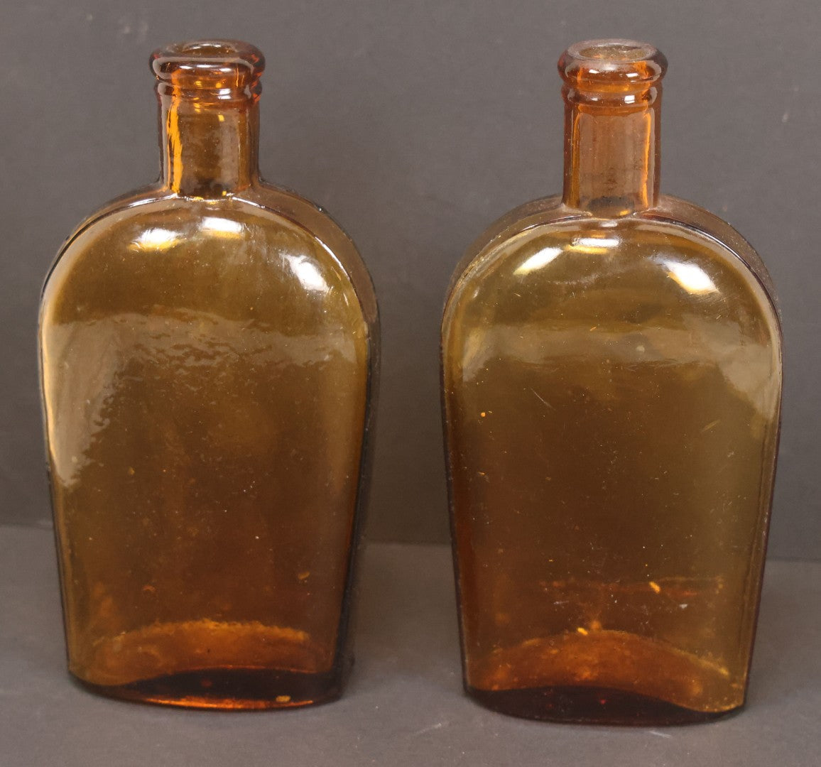 Lot 059 - Pair Of Antique Amber Glass Flask Bottles With Textured Glass