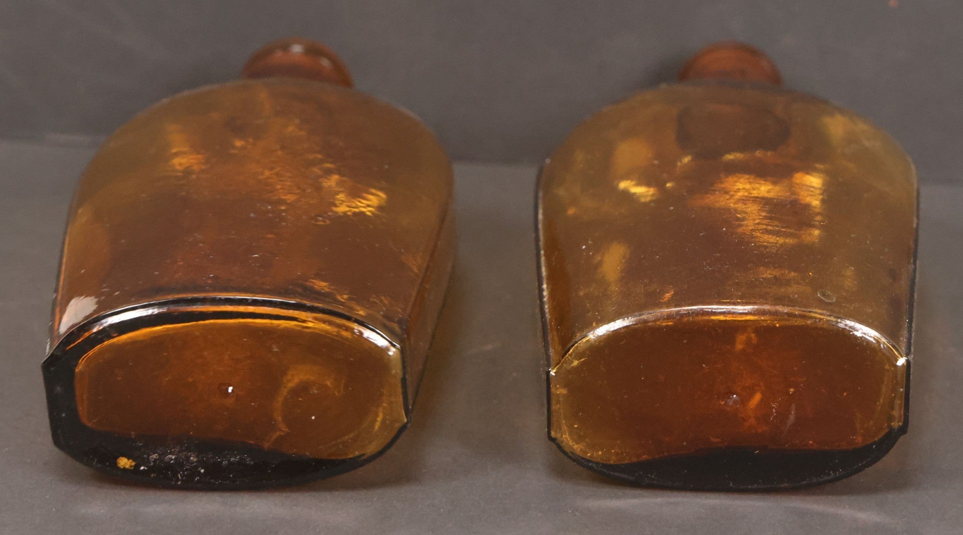 Lot 059 - Pair Of Antique Amber Glass Flask Bottles With Textured Glass
