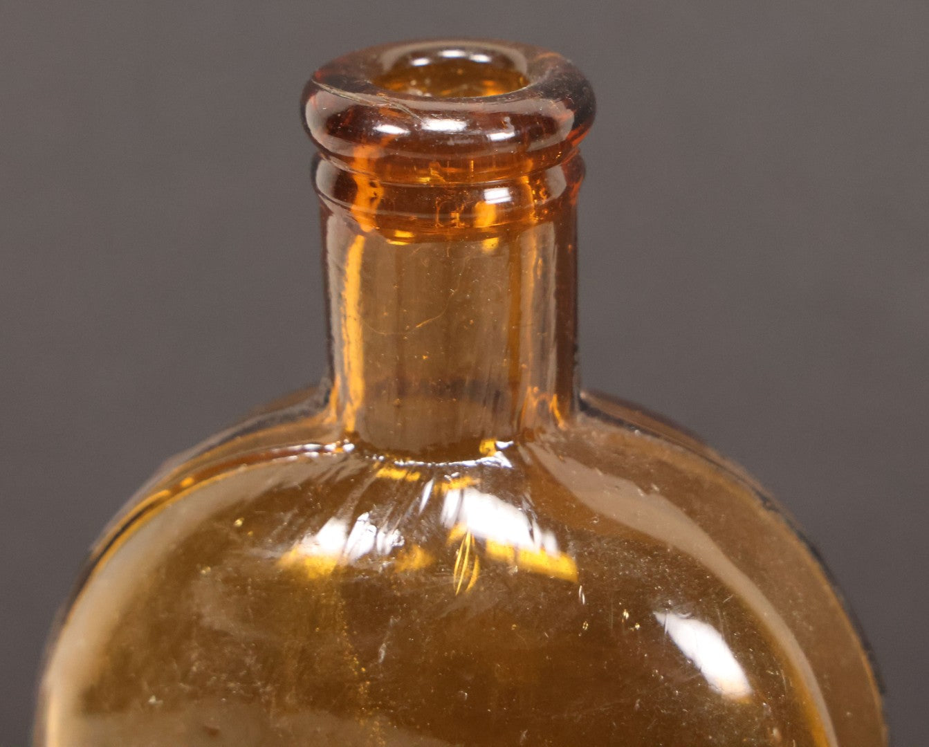 Lot 059 - Pair Of Antique Amber Glass Flask Bottles With Textured Glass